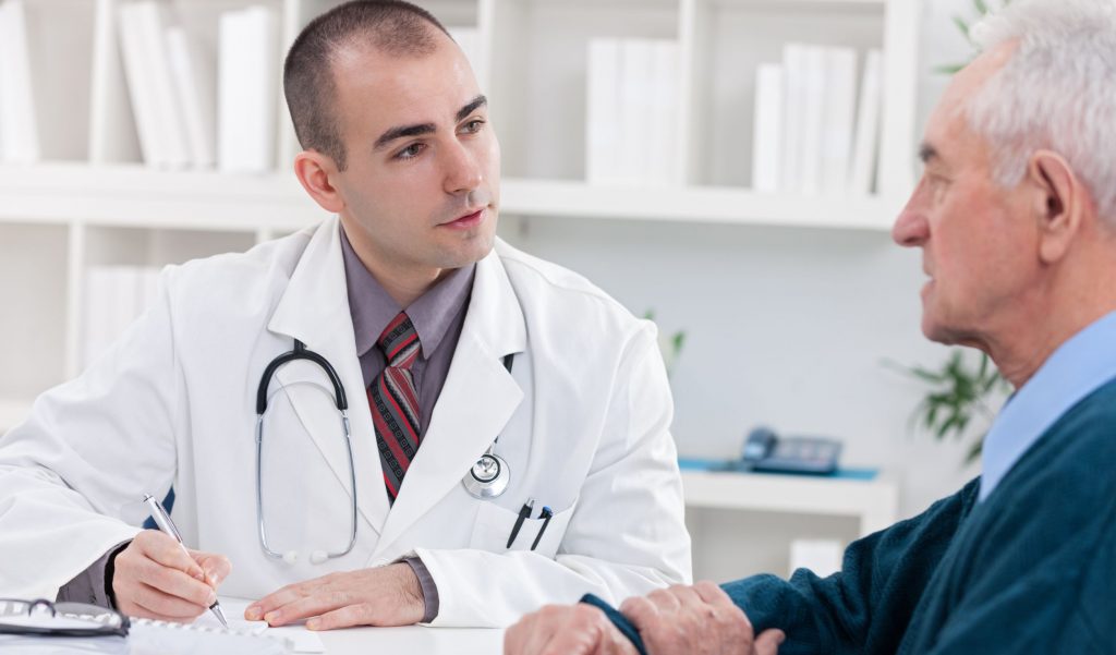 Doctor speaking with patient and taking notes