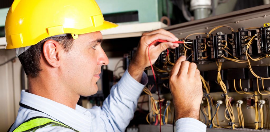 Industrial electrician working on a machine