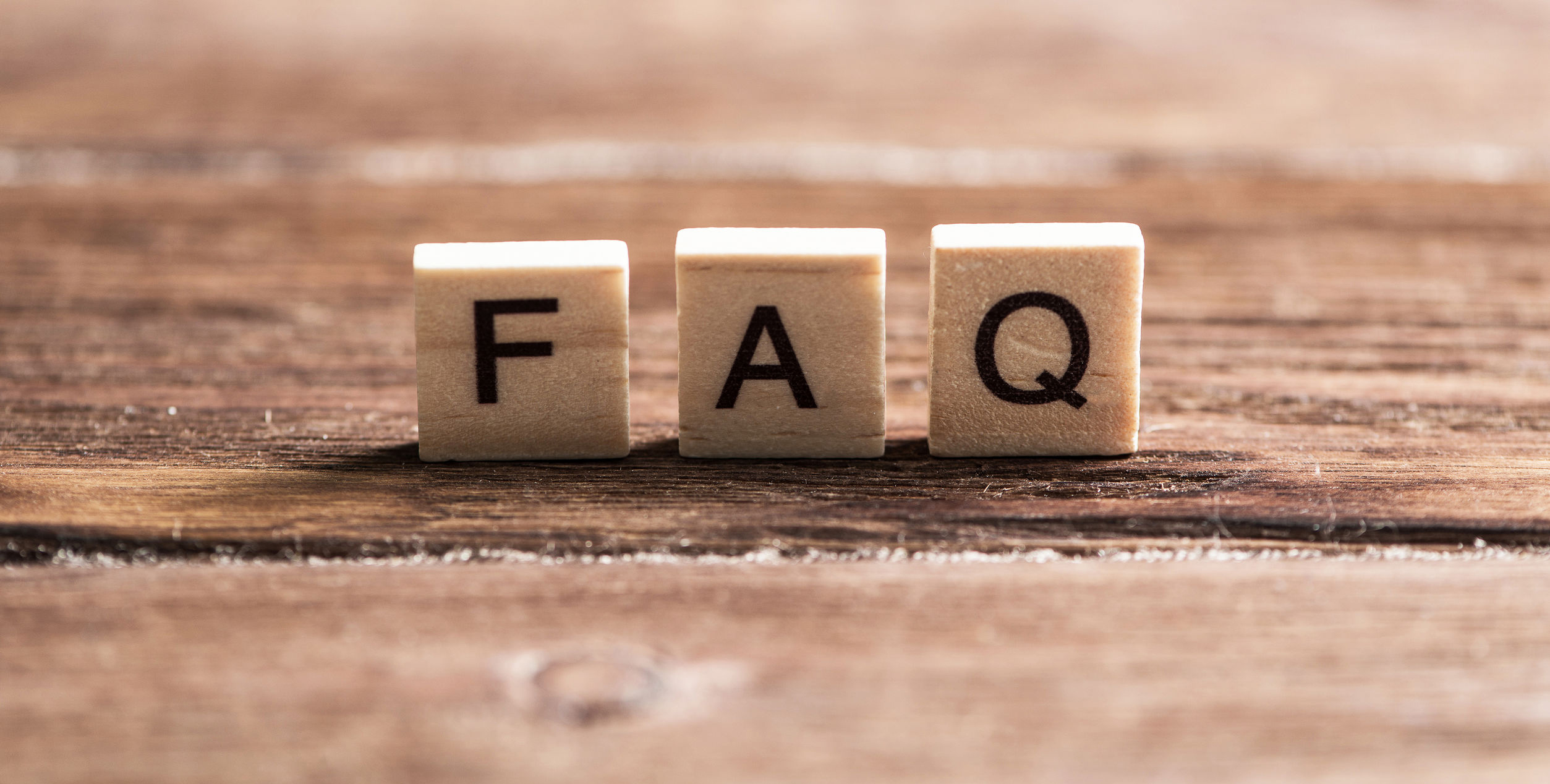 Letters on wooden blocks spelling FAQ