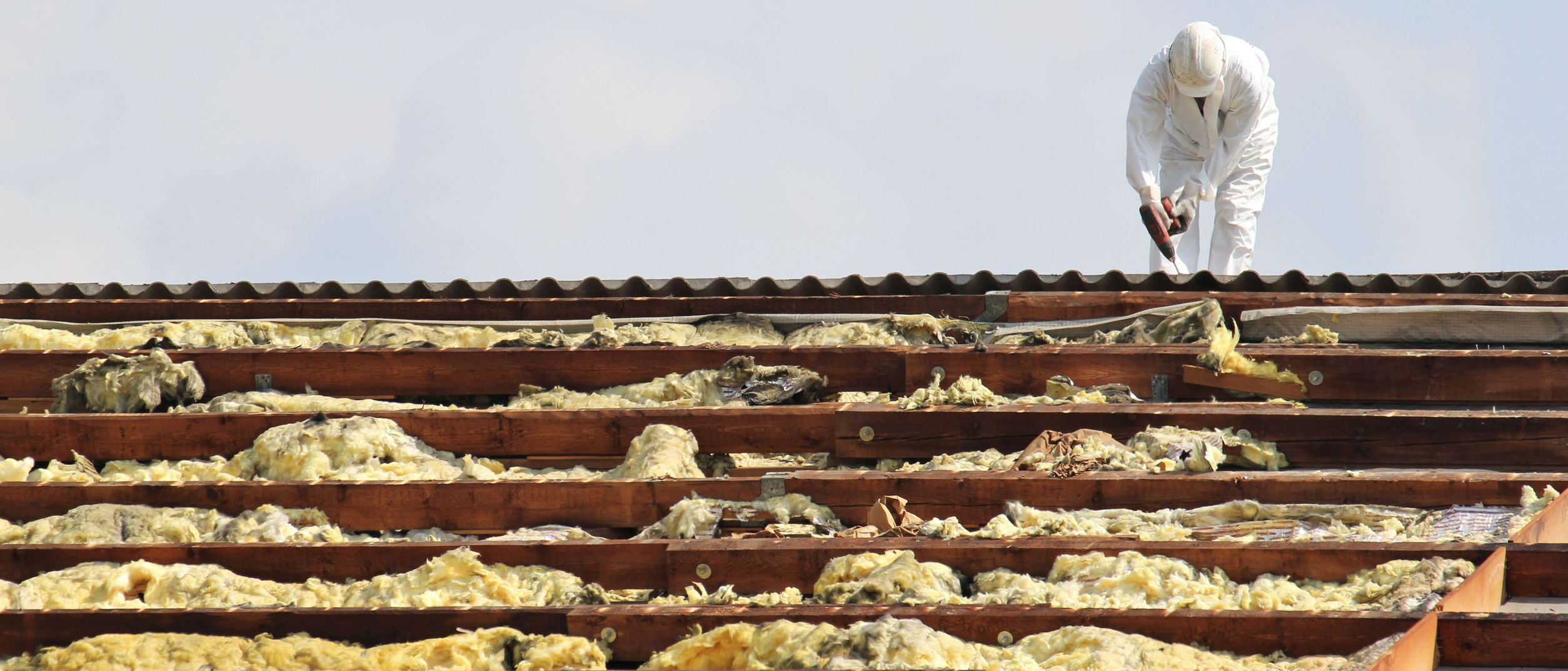 Workman at rooftop of building being remediated