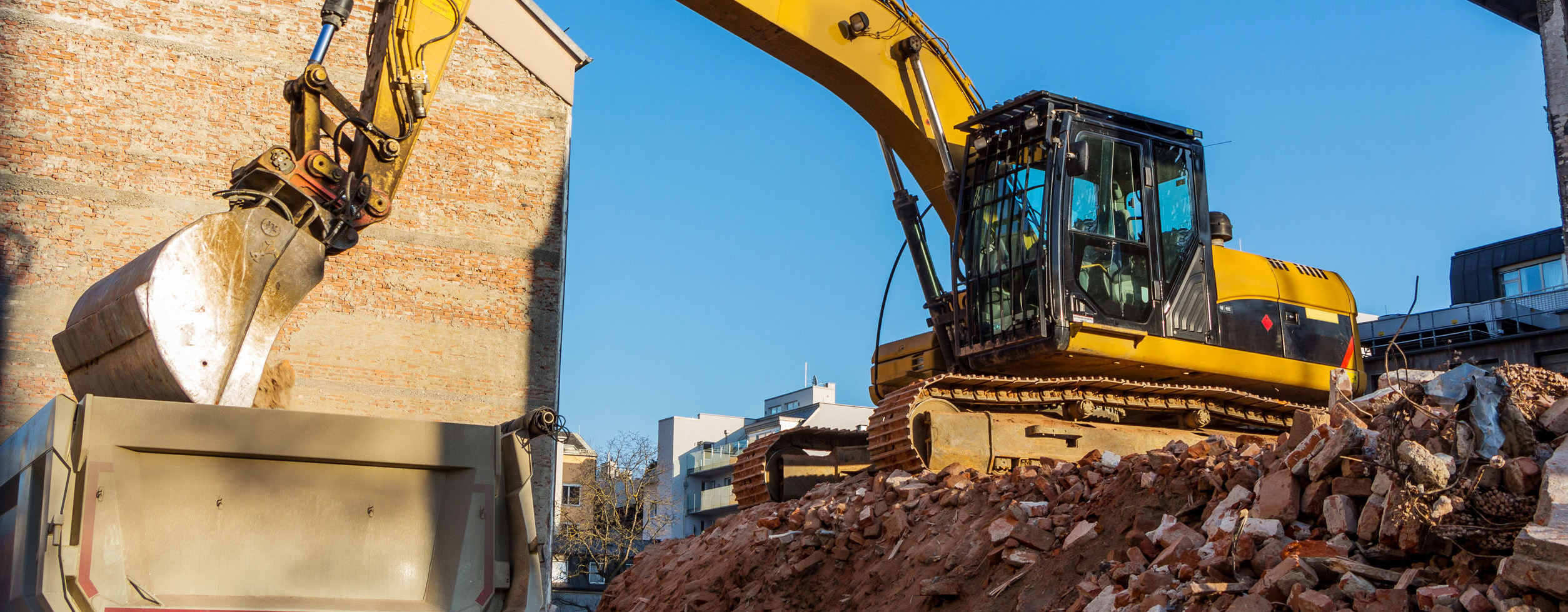 Excavator on a construction site during the demolition of a house