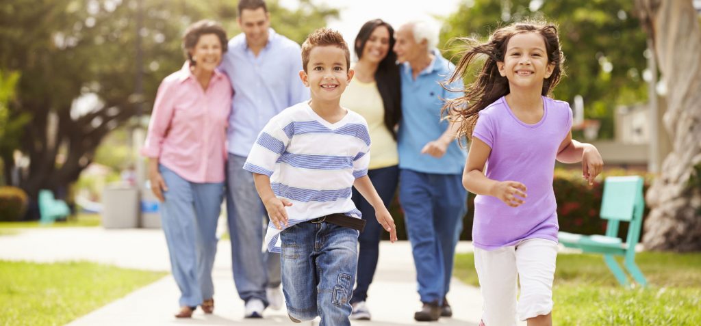 Multi generational family walking in park