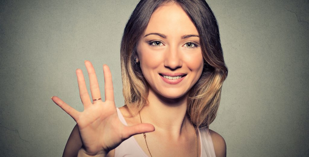 Smiling woman making high five with her hand