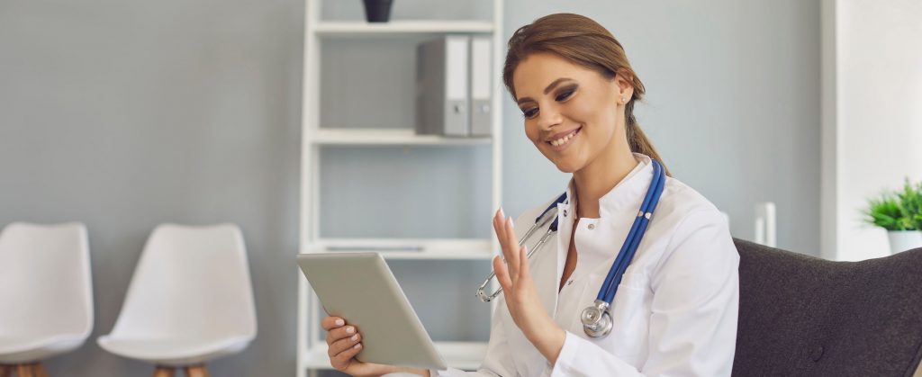 Doctor consulting with patient through tablet