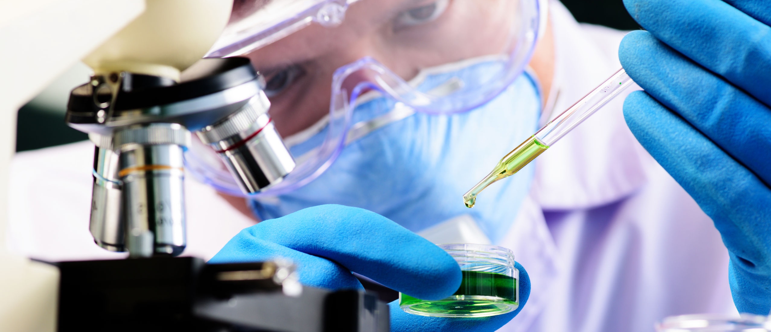 Conical flask in scientist hand with lab glassware