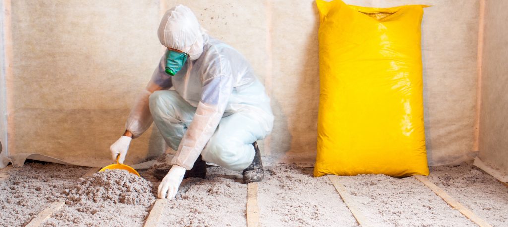 Man working with insulation in a home