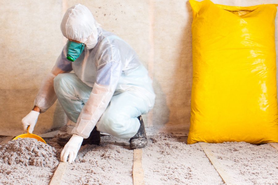 Man working with insulation in a home