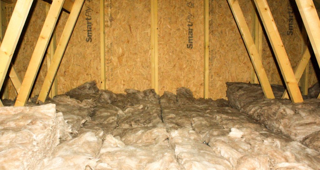 Insulation lining the roof of a residential attic