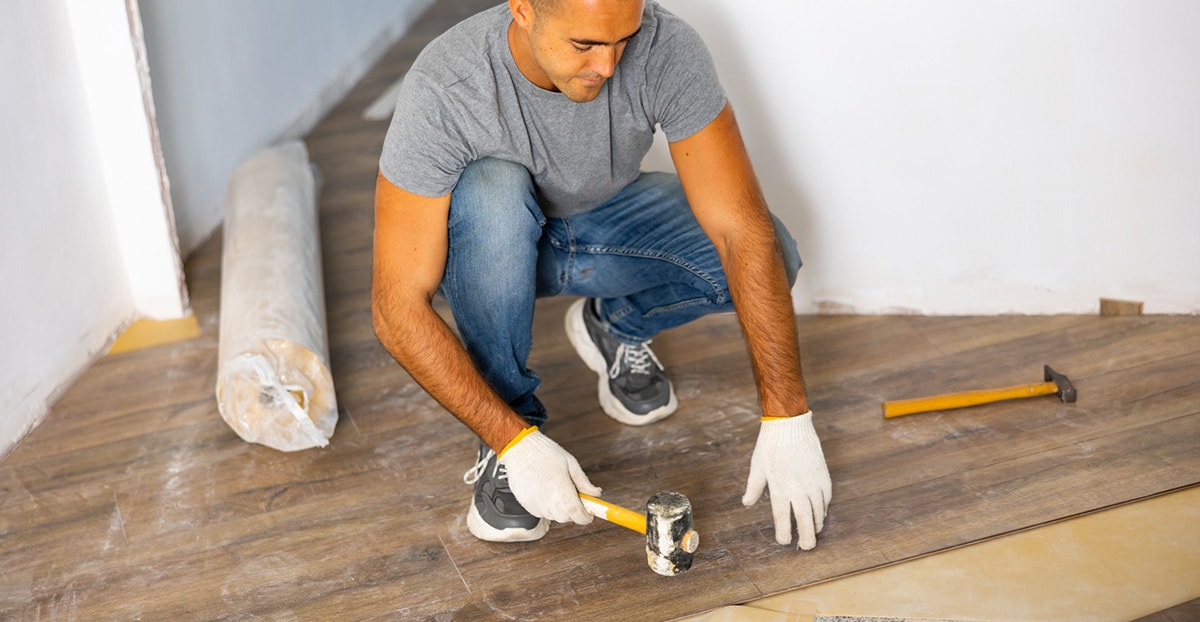 Man installing flooring in a home